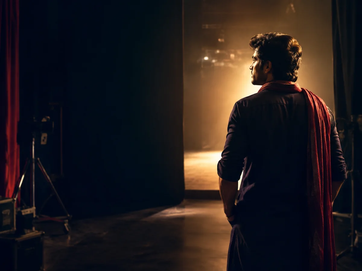 An aspiring Indian screen performer stepping toward a film set spotlight